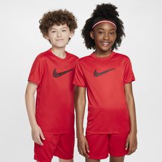 two children wearing red nike soccer uniforms