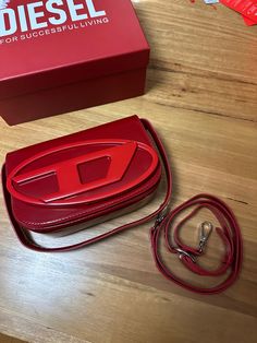 Diesel 1DR Bag in Metallic Red Leather  - Like new condition - No flaws or scratches - Comes with shoulder strap. box and dust bag, - No refunds - No uses and returns Red Logo Crossbody Shoulder Bag, Red Rectangular Bag With Logo, Red Rectangular Bags With Logo, Designer Red Shoulder Bag With Logo, Red Designer Shoulder Bag With Logo, Diesel 1dr Bag, Red Logo Shoulder Bag, Red Shoulder Bag With Logo, Red Bag For Everyday Use