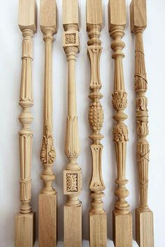 a collection of carved wooden balconies on display against a white wall with an ornate carving