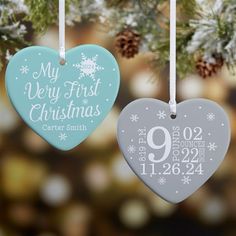 two heart shaped ornaments hanging from a christmas tree