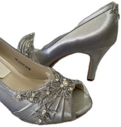 Fitted Silver Wedding Shoes With 4-inch Heel, Silver Fitted Heels For Wedding, Metallic Silver High Heel Wedding Heels, Metallic Silver High Heels For Wedding, Silver Wedding Shoes With 4-inch Heel, Silver Almond Toe Wedding Shoes For Evening, Silver Embellished Heels With Almond Toe, Fitted Silver Heels With Almond Toe, Silver Open Toe Heels For Wedding