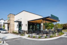 the outside of a restaurant with tables and chairs