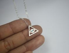 "A Triangle necklace, featuring the evil eye protection charm curved on a sterling silver chain. The classic \"protection from evil\" talisman, that can be an ideal accessory for the casual appearance and can be combined with other symbol jewelry to create a unique style. Let it be your lucky charm! A Classic and elegant Silver All seeing eye necklace This impressive piece Triangle Evil Eye Necklace would make a great mother gift .two sisters present, gift for daughter,friendship gifts for best Evil Eye Metal Jewelry For Gifts, Evil Eye Metal Jewelry Gift, Metal Evil Eye Jewelry For Gift, Symbolic Eye-shaped Jewelry Gift, Symbolic Sterling Silver Evil Eye Jewelry, Silver Evil Eye Symbolic Necklace, Silver Symbolic Evil Eye Necklace, Silver Evil Eye Jewelry Gift, Symbolic Eye-shaped Silver Jewelry