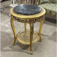 an ornately decorated table with black marble top