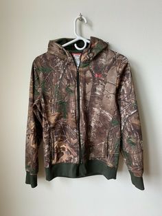 Up for sale is an Under Armour Storm Camo Hoody jacket size Medium.  This jacket is in EXCELLENT used condition with minor signs of use as can see from the pictures. Please email with questions.  This item will ship one day after payment is received.  Payment is required within 48 hours.  Thanks for looking!!   Here are the dimensions, please use these to ensure proper fit:   Chest from armpit to armpit:  19 inches   Length from top of shoulder to bottom: 25 inches Arm from armpit to end:  21 in Camouflage Sweatshirt For Winter Outdoor Activities, Outdoor Fall Sweatshirt With Double-lined Hood, Fall Outdoor Sweatshirt With Double-lined Hood, Fall Outdoor Fleece Jacket With Kangaroo Pocket, Outdoor Camouflage Sweatshirt With Drawstring Hood, Camouflage Sweatshirt With Drawstring Hood For Outdoor, Under Armour Outerwear For Fall Outdoor Activities, Camouflage Long Sleeve Outdoor Hooded Jacket, Camouflage Long Sleeve Hooded Jacket For Outdoor