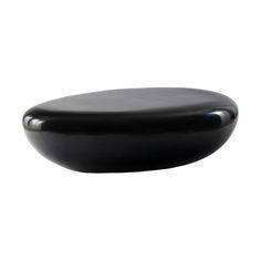 a black round object sitting on top of a white surface