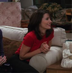 two women sitting on a couch talking to each other