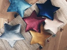 four star shaped pillows on the floor