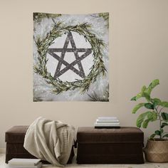 a wall hanging in a living room with a pentagramil on it and some plants