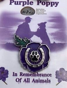 the purple poppy pin has an image of a dog's paw on it, and is