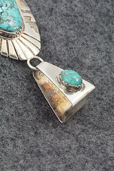 This vintage Morenci turquoise and sterling silver pendant was made by Navajo silversmith Oliver Smith. The back is signed O. Smith and stamped .925. The silver retains an aged patina.Length: 3 3/8"Width: 1 5/8"Free shipping on all orders! We ship with USPS and always include tracking. All orders ship within a day of payment.Returns are accepted up to 30 days after you receive your order. Just send us a message. Our shop offers cash back or store credit. The item must be returned in new conditio Vintage Sterling Silver Turquoise Necklace With Patina, Vintage Silver Turquoise Necklace With Patina, Southwestern Silver Turquoise Necklace With Patina, Vintage Turquoise Pendant Necklace With Patina, Collectible Sterling Silver Turquoise Necklace With Patina, Vintage Sterling Silver Concho Necklace, Vintage Sterling Silver Concho Necklaces, Sterling Silver Turquoise Necklace With Patina, Vintage Turquoise Necklace With Concho Detail