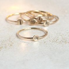 A teensy tinsy silver personalized initial ring so cute you'll fall in love!  This listing is for 14/20 gold filled. Customize this delicate stacking ring with the initial or symbol you desire for a very wearable, everyday ring.  The slim 1mm band and 4mm disk (slightly smaller than our original 5mm round - see comparison photo) makes this literally THE most perfect ring for stacking! Just the right find for a lucky momma or grandmother of many. Also sweet for creating a short word by stacking m Simple Personalized Initial Ring For Everyday, Gold Stackable Rings With Initials For Everyday, Everyday Gold Stackable Rings With Initials, Adjustable Initials Stackable Rings For Everyday, Simple Personalized Gold Stackable Rings, Personalized Gold Initial Ring Minimalist Style, Gold Minimalist Personalized Initial Ring, Personalized Gold Minimalist Initial Ring, Minimalist Personalized Gold Initial Ring