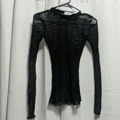 Black Long Sleeve See Through Shirt. Never Worn Black Sheer Long Sleeve Shirt, Fitted Black Sheer Shirt, Black Fitted Top For Layering, Fitted Sheer Black Shirt, Fitted Black Top For Layering, Sheer Tops For Winter Layering, Black Mesh Crew Neck Top For Layering, Fitted Black Long Sleeve Top For Summer, Sheer Crew Neck Tops For Fall