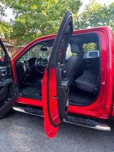 the interior of a red truck with its doors open