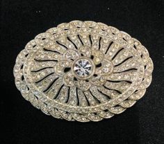 This is a beautiful silver toned  vintage Art Deco brooch. The rhinestone work is beautiful on this piece. A absolute statement piece. Perfect for any collector, or gift. Vintage Evening Brooches With Rhinestones, Vintage Rhinestone Brooches For Evening, Elegant Silver Brooches For Vintage Events, Art Deco Oval Wedding Brooches, Vintage Rhinestone Brooches For Vintage Events, Formal Rhinestone Costume Brooches, Elegant Rhinestone Brooches For Anniversary, Silver Victorian Brooch For Vintage Events, Victorian Silver Brooch For Vintage Events