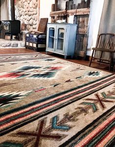 a living room area with rugs and chairs