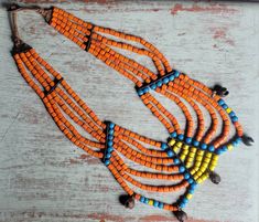 "Antique 7 strand beaded Naga heirloom necklace with 5 bronze bells. Heavy, 15\" long. From Northern India/Nagaland/Nepal." Traditional Brown Multi-strand Necklaces, Traditional Multi-strand Wooden Bead Necklaces, Traditional Orange Multi-strand Jewelry, Traditional Multi-strand Polished Beads, Traditional Orange Necklaces With Dangling Beads, Traditional Orange Necklace With Dangling Beads, Traditional Hand-strung Multi-strand Beads, Heirloom Necklace, Katy Tx