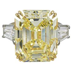 This Art Deco-inspired platinum and 18K gold ring made by Spectra Fine Jewelry in 2022 is stunning as a cocktail, engagement, or celebration ring, featuring a very large emerald-cut fancy yellow diamond, weighing approximately 23.16 carats. The diamond is accompanied by report from the Gemological Institute of America (GIA) stating that it is a natural diamond of fancy yellow color and even distribution with VS1 clarity. The central stone is accented with two tapered baguettes of I color and VS2 Loui Vuttion, Celebration Ring, Fancy Yellow Diamond Ring, Yellow Diamond Ring, Yellow Diamond Engagement Ring, Canary Diamond, Expensive Rings, Yellow Diamond Rings, Fancy Yellow Diamond