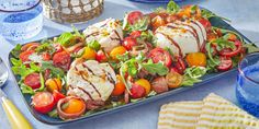 a platter filled with lots of different types of food on top of a table