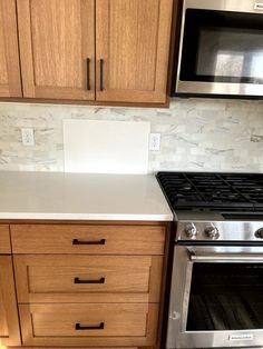 a stove top oven sitting inside of a kitchen next to wooden cabinets and cupboards