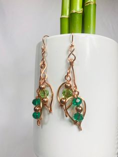 These earrings are made of copper with Glass beads in shades of green. They consist of a couple of leaf shaped. They are 3 inches long by a half an inch wide. They weigh .34 of an ounce Bead Dangle Earrings, Red Tigers Eye, Beaded Dangle Earrings, Etsy Earrings Dangle, Beaded Dangles, Soft Yarn, Leaf Shapes, Colorado Springs, Glass Bead