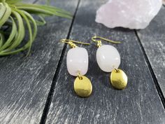 "These boho dangle earrings feature 14mm x 10mm rose quartz nuggets with small 8mm x 10mm gold-plated oval charms dangling from the bottom. Rose Quartz is known as the stone of universal love, and is said to restore trust and harmony in relationships and encourage unconditional love. Rose Quartz purifies and opens the heart at all levels to promote love, self-love, friendship, deep inner healing, and feelings of peace. These lightweight earrings measure approximately 1 7/8 inches from the top of Nickel-free Rose Quartz Dangle Earrings, Handmade Rose Quartz Dangle Earrings, Rose Quartz Gemstone Dangle Earrings, Rose Quartz Drop Earrings For Jewelry Making, Pink Quartz Jewelry, Nugget Earrings, Geometric Rose, Rose Quartz Jewelry, Rose Gold Quartz