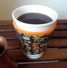 a cup of coffee sitting on top of a wooden table