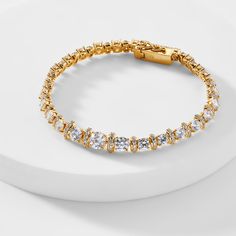 ABOUT THE PRODUCTA modern classic, this stunning tennis bracelet features an alluring mix of dazzling cubic zirconia stones, adding a touch of elegant glamour to any look. Metal: BrassPlating: 18KT Gold or RhodiumStones: Cubic ZirconiaLength: 7.25 in Classic Cubic Zirconia Tennis Bangle Bracelet, Fine Gold Bracelet With Cubic Zirconia, Diamond Accented Bangle Tennis Bracelet For Party, Timeless Tennis Bracelet With Jubilee Style In Cubic Zirconia, Elegant Diamond Tennis Bracelet, Timeless Cubic Zirconia Tennis Bracelet, Elegant Diamond White Tennis Bracelet With Brilliant Cut, Elegant Diamond White Brilliant Cut Tennis Bracelet, Party Tennis Bangle Bracelet With Diamond Accents