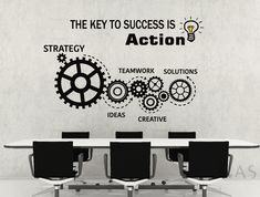 the key to success is action wall decal on a conference room table with black chairs