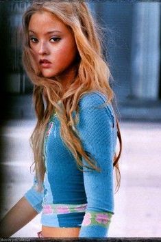 a woman with long blonde hair and blue shirt