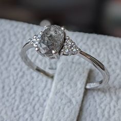 a diamond ring sitting on top of a white towel