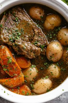 a white bowl filled with meat, potatoes and carrots