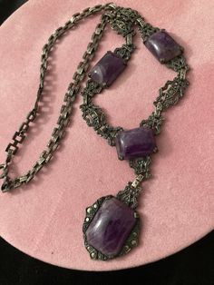 "COUPON CODE available at check out.  Antique 19th C Medieval Revival sterling amethyst stone pendant necklace. 13 marcasites dot this necklace. There are patterns within patters. Faux marcasite studs thru out. Picture frame style  filigree cut out sturdy flat solid sterling panels for bottom half of necklace.  An intricate flat square interlocking chain for the upper half. The square chain links are all intricately designed.  Back of center pendant is marked sterling.  Largest stone MEASURES:  Approx 3/4\" x 1/2\" (little more). Next 3 measure the same at approx: 1/2\" x 1/2\" (a little more.) Purple stone is freezing cold to the touch. Regular flashlight shown under light. See all photos. No cracks in any stones. Email any questions prior to purchase.  My opinion of the style might be di Antique Handmade Purple Jewelry, Handmade Antique Purple Jewelry, Antique Amethyst Jewelry Gift, Vintage Amethyst Jewelry For Gifts, Collectible Spiritual Purple Necklace, Victorian Antique Silver Pendant Necklace, Antique Sterling Silver Purple Jewelry, Antique Purple Sterling Silver Jewelry, Antique Silver Gemstone Necklace