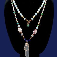 This exquisite necklace is a true masterpiece. The jade beads boast a deep green hue that exudes both a sense of tranquility and vitality. The pearls, on the other hand, are a gentle white that lends an air of sophistication. The quartz pendant is a clear crystal that glows like magic, reflecting light in a mesmerizing manner. The copper ornamentation, meanwhile, imparts a hint of refinement and warmth. This necklace is perfect for the woman who desires to feel confident and beautiful, and who wishes to make a statement. Whether you're dressing up for a special occasion or simply running errands, this necklace will infuse your ensemble with a touch of glamour. When you don this necklace, you'll feel like royalty. You'll feel empowered and beautiful, as if you could conquer anything. Sophisticated Jewelry, Feel Empowered, Quartz Pendant Necklace, Reflecting Light, Jade Beads, Quartz Pendant, Quartz Necklace, Deep Green, Feel Confident