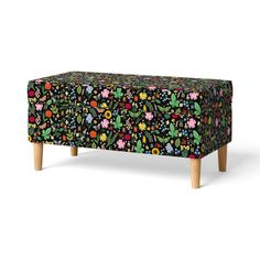 an upholstered bench with colorful flowers on it