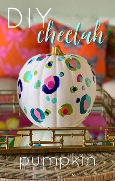 a diy painted pumpkin sitting on top of a wicker tray with the words, diy cheetoh