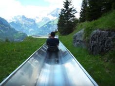 a person riding down a long metal slide