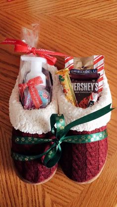 two slippers that are sitting on top of a wooden table with candy and candies in them