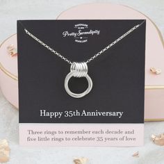 an anniversary card with a silver necklace on it