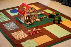 a child's play area with toys on the floor and rugs around it