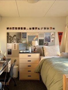 a bedroom with a bed, desk and pictures on the wall