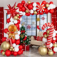 a christmas themed living room decorated with balloons, candy canes and gingerbread man