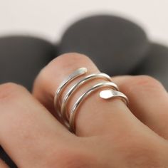 This simple coiled ring wraps around your finger like a snake or a spring. It is mostly smooth, except for the hammered ends, which overlap on the front for the perfect kind of statement ring. It's available in recycled sterling silver, gold or rose gold fill. I will gladly make the ring as either a knuckle ring or as a traditional ring for regular wear at the base of the finger.Made from recycled sterling silver or gold fill. The photographed ring is 3 wraps, for reference.If you need more time Adjustable Spiral Midi Rings In Minimalist Style, Adjustable Spiral Snake Ring As Gift, Ring Wraps, Traditional Ring, Spiral Ring, Knuckle Ring, Knuckle Rings, A Snake, Wrap Rings