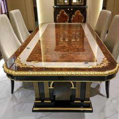 a dining table with chairs around it in a room that has marble floors and walls