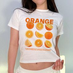 This Orange Graphic Baby Tee is a must-have for any fashion-forward woman! Its aesthetic design and trendy Y2K 90s vibe make it a perfect addition to any wardrobe. Not only is it a great gift for yourself, but also for a stylish friend. Stand out with this eye-catching top! The model is wearing an XS size. Fruit Letters, Trendy Tees, Baby Graphic Tees, Orange Baby, Orange You Glad, Emotional Body, Baby Tees, Fashion Statements, 90s Nostalgia