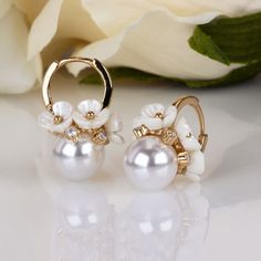 Elevate your special day with our exquisite Spring Blossom Floral Pearl Earrings. Delicately crafted to capture the essence of blooming flowers, these earrings are the perfect accessory to add a touch of elegance and charm to any outfit.Trendy Spring Style: Embrace the spirit of the season with our trendy floral pearl earrings, perfect for springtime gatherings, weddings, or everyday wear.Versatile Elegance: Whether paired with a casual sundress or a sophisticated evening gown, these earrings effortlessly enhance any ensemble with a touch of glamour.Handcrafted Quality: Each pair of earrings is meticulously handcrafted by skilled artisans, ensuring exceptional quality and attention to detail.Thoughtful Gift: Surprise a loved one with these beautiful pearl earrings, packaged in a cute gift Elegant Dangle Clip-on Flower Earrings, Dangle Flower Earrings With 3d Flowers, Elegant Clip-on Dangle Flower Earrings, Elegant Flower-shaped Hoop Earrings Gift, Elegant Rose Gold Flower Clip-on Earrings, Elegant Flower-shaped Hoop Earrings For Anniversary, Wedding Clip-on Flower Earrings, Flower Shaped Clip-on Earrings For Wedding, Flower-shaped Earrings For Wedding