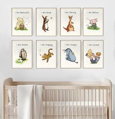 a baby's room with four framed pictures on the wall and a crib