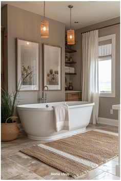 a bath tub sitting next to a window in a bathroom on top of a rug