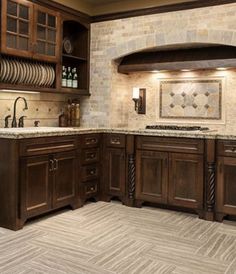 a kitchen with wooden cabinets and marble counter tops