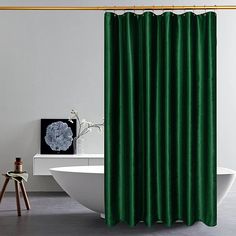 a bath room with a tub and a shower curtain on the wall next to a chair